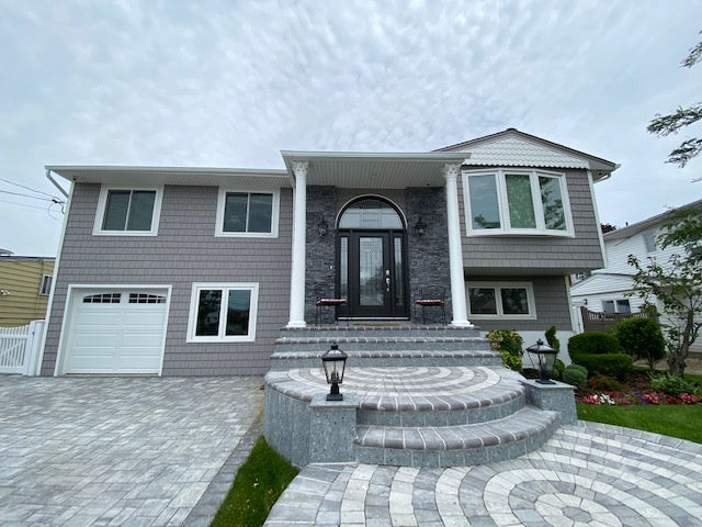 This is Beautiful Cedar Impression Siding with exquisite paver and stone work done by our experienced and professional team